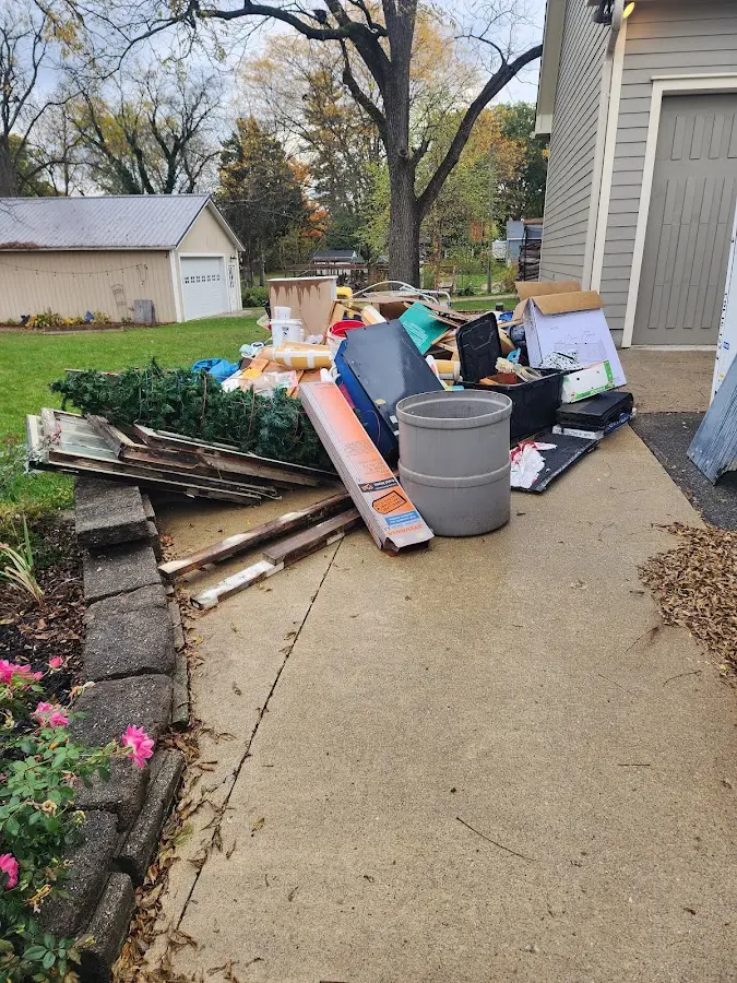 Dumpster being loaded with debris for Estate Cleanout Dumpster Rental in Spring Arbor